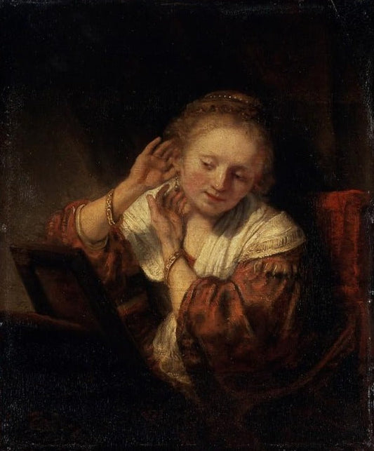 Jeune femme essayant des boucles d'oreilles - Rembrandt van Rijn - Reproductions de tableaux et peintures haut de gamme